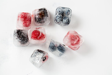 ice cube with raspberry and blueberry