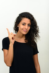 Portrait of young beautiful Hispanic woman with curly hair