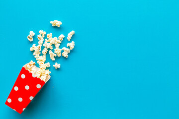 Popcorn in red dotted paper cup top-down space for text