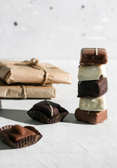 Chocolates with cinnamon and cocoa. On a gray background.