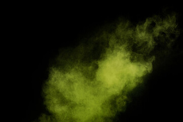 Light green powder explosion on black background. Colored powder cloud. Colorful dust explode. Paint  Holi.