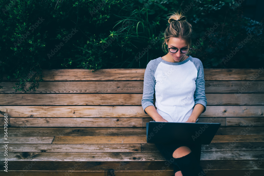 Aufkleber hipster girl enjoying doing remote job outdoors using laptop computer and internet connection in tow