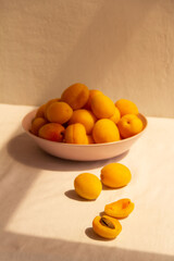 apricots in a plate on a light background in the morning light