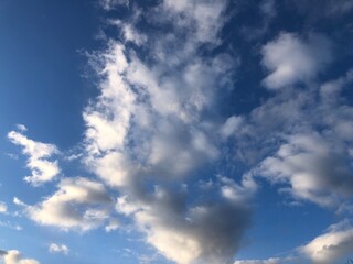 Blue sky and white feathery clouds. Copy space and background.