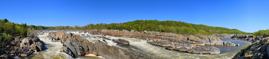 A panormaic view of Great Falls on Potomac River, on the border of Maryland and Virginia on a clear blue skies day