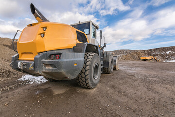 Heavy machinery at a construction site, excavators moving rock and stone.