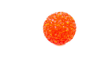 Bright red, orange ball for cats in macro on a white background