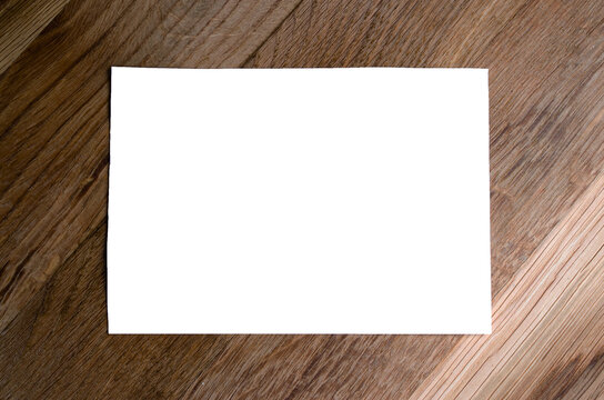 White Sheet Of Paper On A Wooden Background. Mock Up