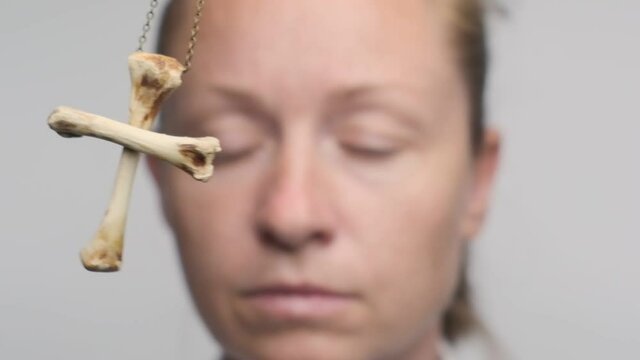 pendulum is swinging in face of woman in hypnosis close up. hypnotized businesswoman closes her eyes and falls asleep.