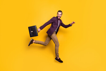 Full size profile photo of handsome stylish business guy jump high up rushing work office hold...