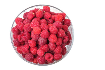 Fresh raspberries in a glass bowl isolated on a white background