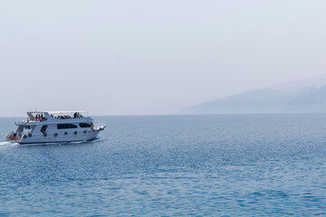 Boat yachting in the blue quiet sea, landscape of ship in calm open ocean