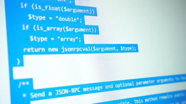 Scrolling selected computer code over laptop screen.