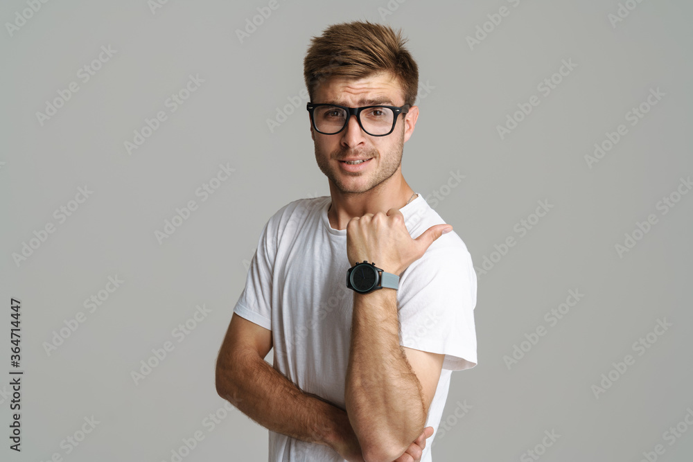 Wall mural portrait of handsome redhead man posing and pointing finger aside