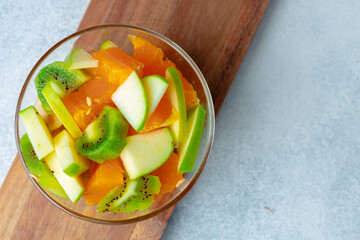 Sliced fresh fruits in a glass bowl