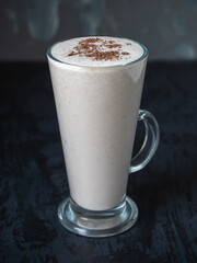 Milkshake with fruits and chocolate in a high glass goblet