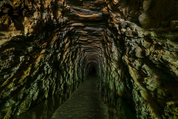 Stumphouse Mountain Tunnel, near Walhalla in rural Oconee County, South Carolina, is an incomplete railroad tunnel. Work on the underground passageway was abandoned in 1859. - obrazy, fototapety, plakaty