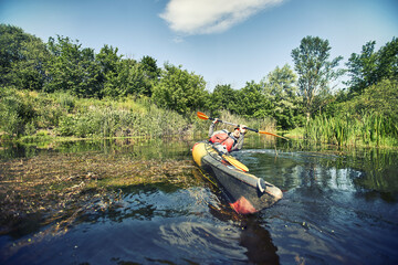 Fototapeta na wymiar Happy best friends having fun on a kayaks. Kayaking on the river.