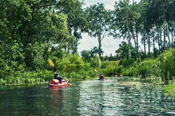 Happy best friends having fun on a kayaks. Kayaking on the river.