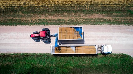 Grain cart unloads grain into a truck 