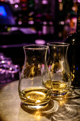 Flight of Scottish whisky, tasting glasses with variety of single malts or blended whiskey spirits on distillery tour in pub in Scotland