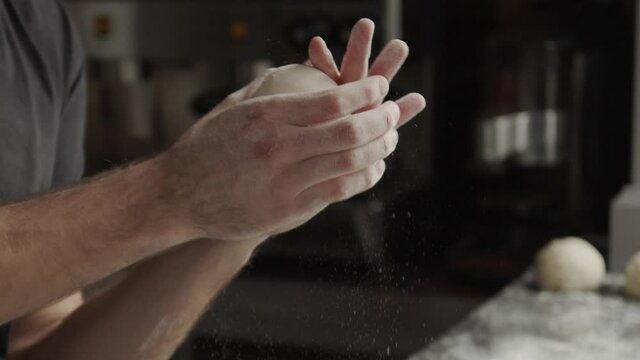 Crop man shaping dough balls