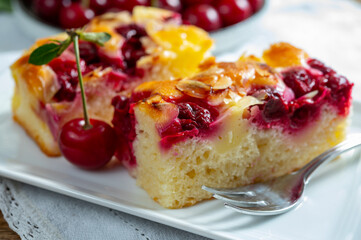 Fresh baked cake with red ripe juicy sour cherry or kriek berry