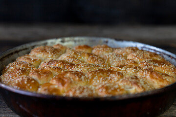 Homemade baked bread on rustic wooden background