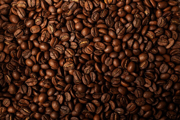 Fototapeta premium Background coffee beans. Pattern of brown roasted coffee bean beans