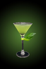 Gin basil smash cocktail isolated on green gradient