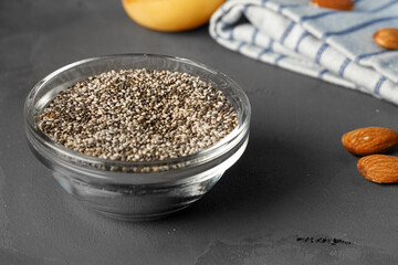 Bowl with raw chia seeds close up