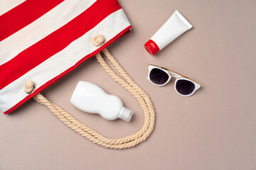 Beach items on beige paper background. Summer vacation concept