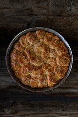 Homemade baked bread on rustic wooden background