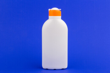 Sunscreen bottle on blue background. Health concepts and skin care