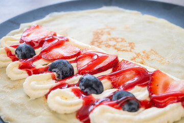 Strawberry and blueberry cream crepes