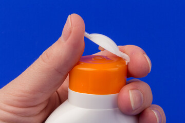 Sunscreen bottle on blue background. Health concepts and skin care