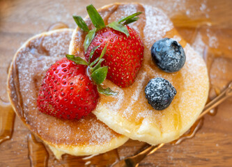 Honey pancake with strawberry and blueberry on top