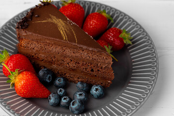 Piece of chocolate cake served with fresh berries
