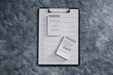 minimalism or introspection concept, notepads with texts Things you need and Things you dont need next to To Do list