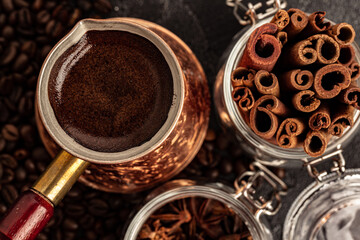 Coffee beans and turk on dark surface