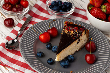 Vanilla cheesecake with chocolate top and berries
