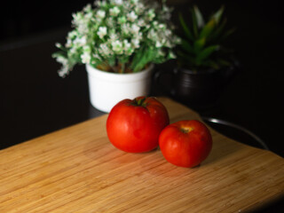 Healthy tomatoes on wooden background top view. Food and health.