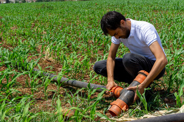Man installing irrigation system on the farm.