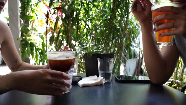 Asian female friends on terrace in cafe