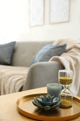 Fototapeta na wymiar Table with decor near sofa indoors. Interior design