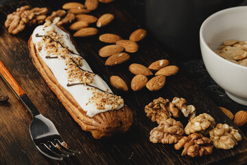 Eclair cake on dark wooden board on black table