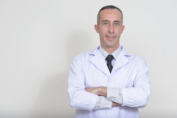 Portrait of mature handsome man doctor against white background