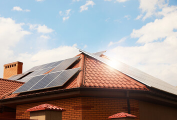 Building with installed solar panels on roof. Alternative energy source