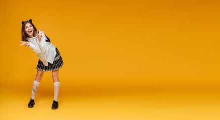 Full length portrait of a happy cheerful schoolgirl in uniform