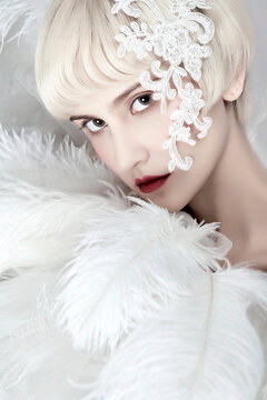 Beautiful white-haired woman holding feathers